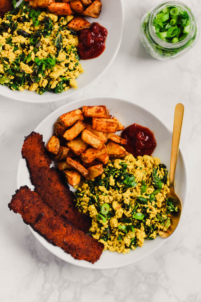 This loaded Vegan Breakfast Plate is the ultimate weekend brunch! It features eggy tofu scramble, veggie bacon, and crispy roasted potatoes.