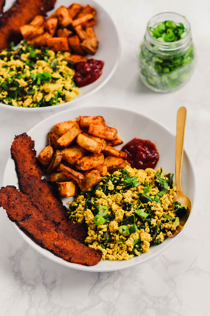 This loaded Vegan Breakfast Plate is the ultimate weekend brunch! It features eggy tofu scramble, veggie bacon, and crispy roasted potatoes.