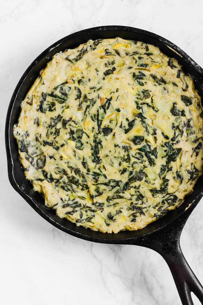 a skillet of vegan artichoke dip