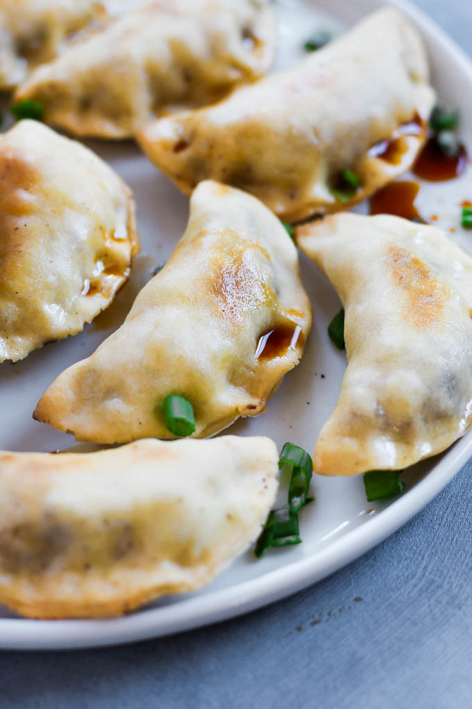 These Sticky Tempeh Potstickers are baked, not fried, and filled with a “meaty” mix of tempeh and vegetables. Serve as an entree or appetizer with soy sauce for dipping! (vegan)