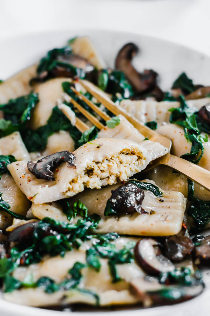 a ravioli cut in half to reveal a vegan tofu ricotta filling