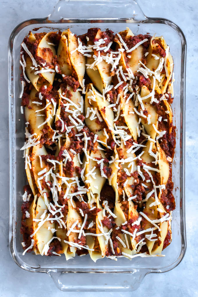These Vegan Lasagna Stuffed Shells will be your family’s go-to comfort food dinner! The shells are stuffed with tofu ricotta and a plant-based, meaty tomato sauce.