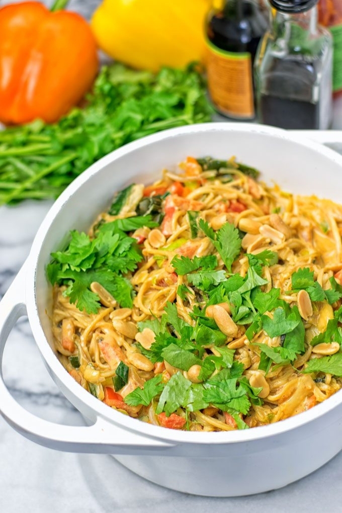 A white dutch oven filled with vegan pad thai