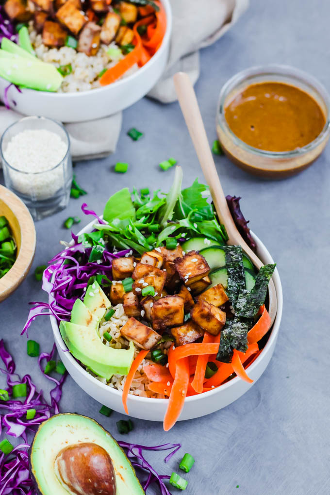 a spoon scooping into a vegan poke bowl