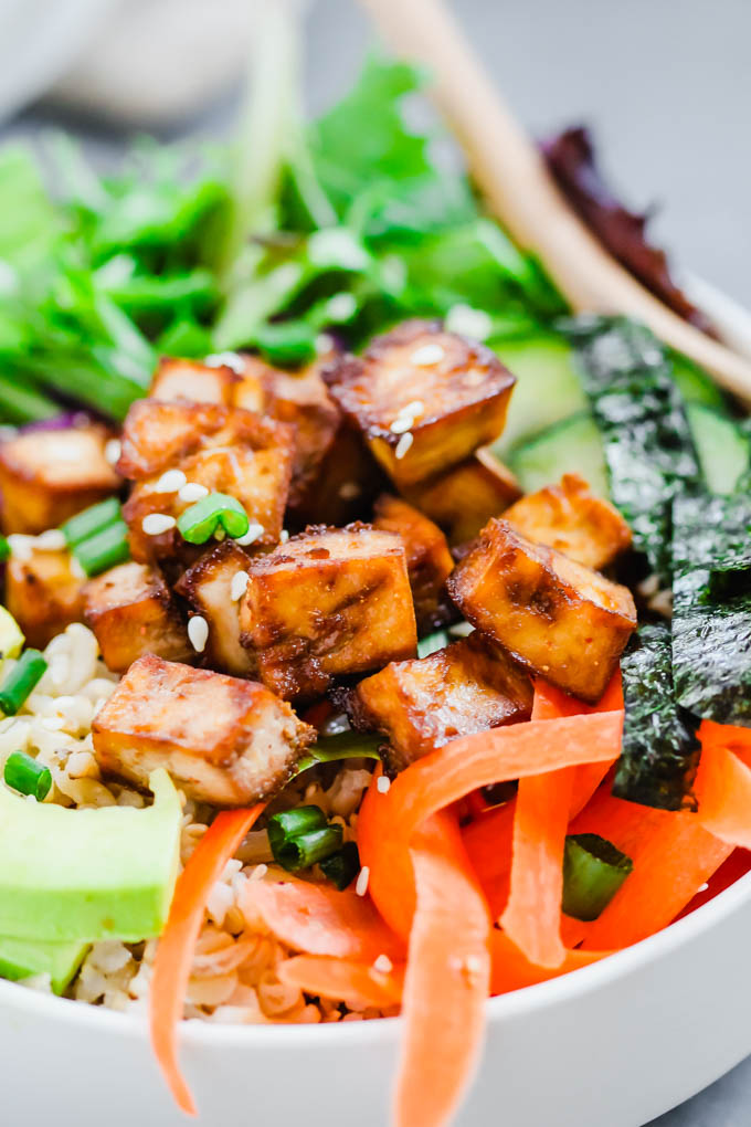 a closeup of roasted tofu in a vegan poke bowl