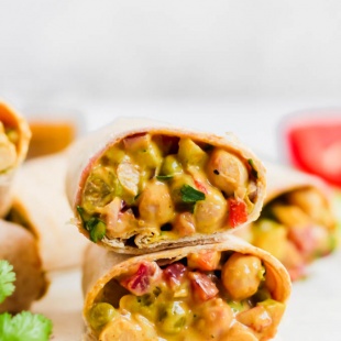 This Curried Chickpea Wrap is a simple, no-cook option for a quick lunch! Filled with beans, vegetables, & a creamy curry sauce, this wrap makes for a nutritious & satisfying meal.