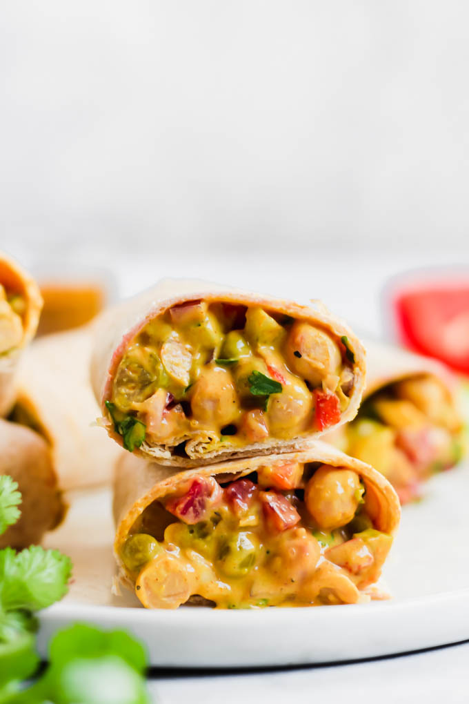 This Curried Chickpea Wrap is a simple, no-cook option for a quick lunch! Filled with beans, vegetables, & a creamy curry sauce, this wrap makes for a nutritious & satisfying meal.