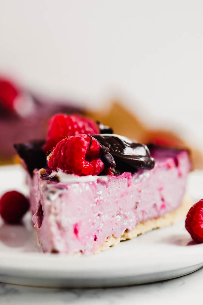 a closeup of a slice of dairy free raspberry cheesecake