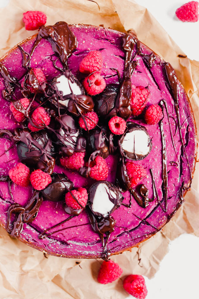 a dairy free raspberry cheesecake topped with chocolate 