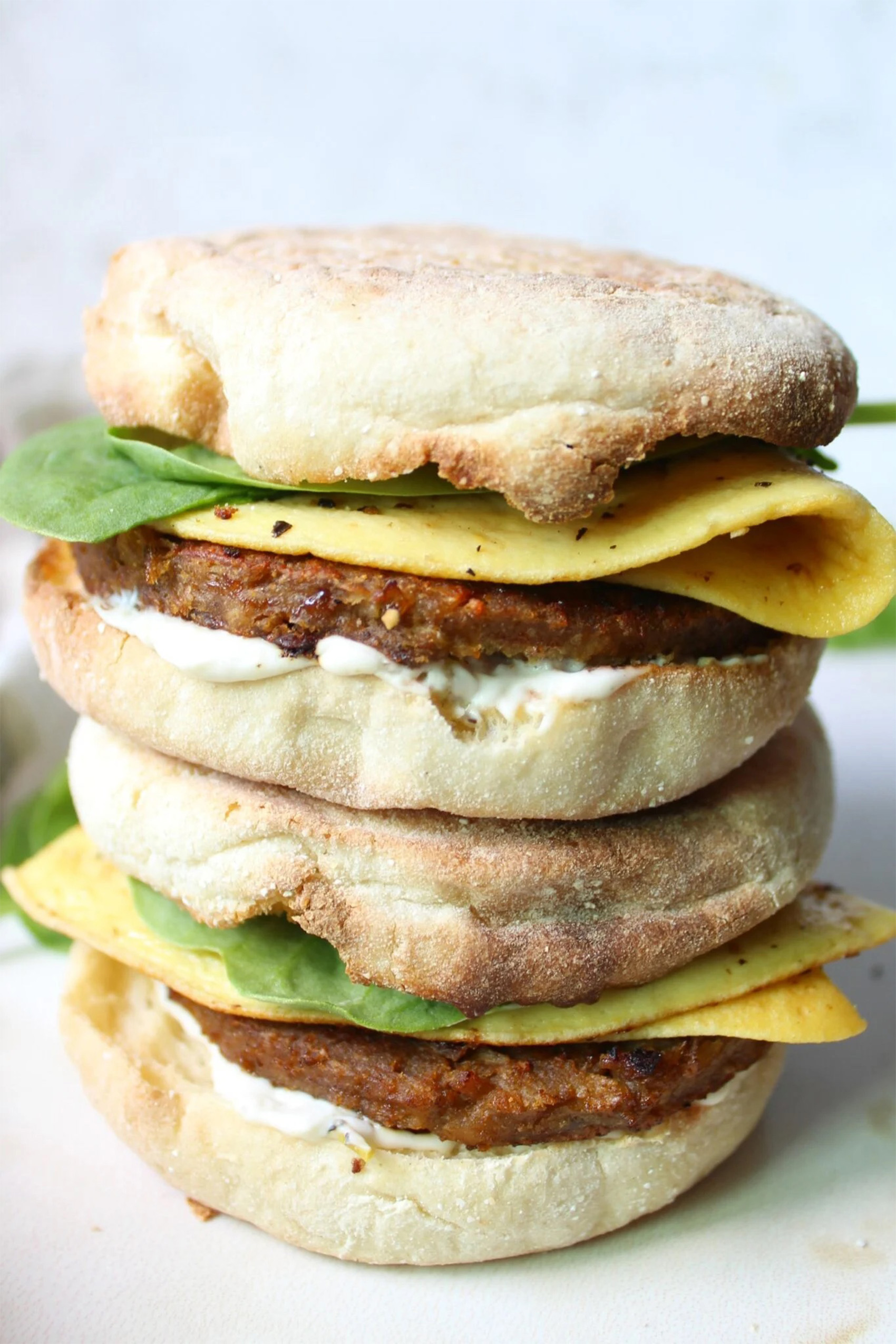 two vegan breakfast sandwiches stacked on top of one another