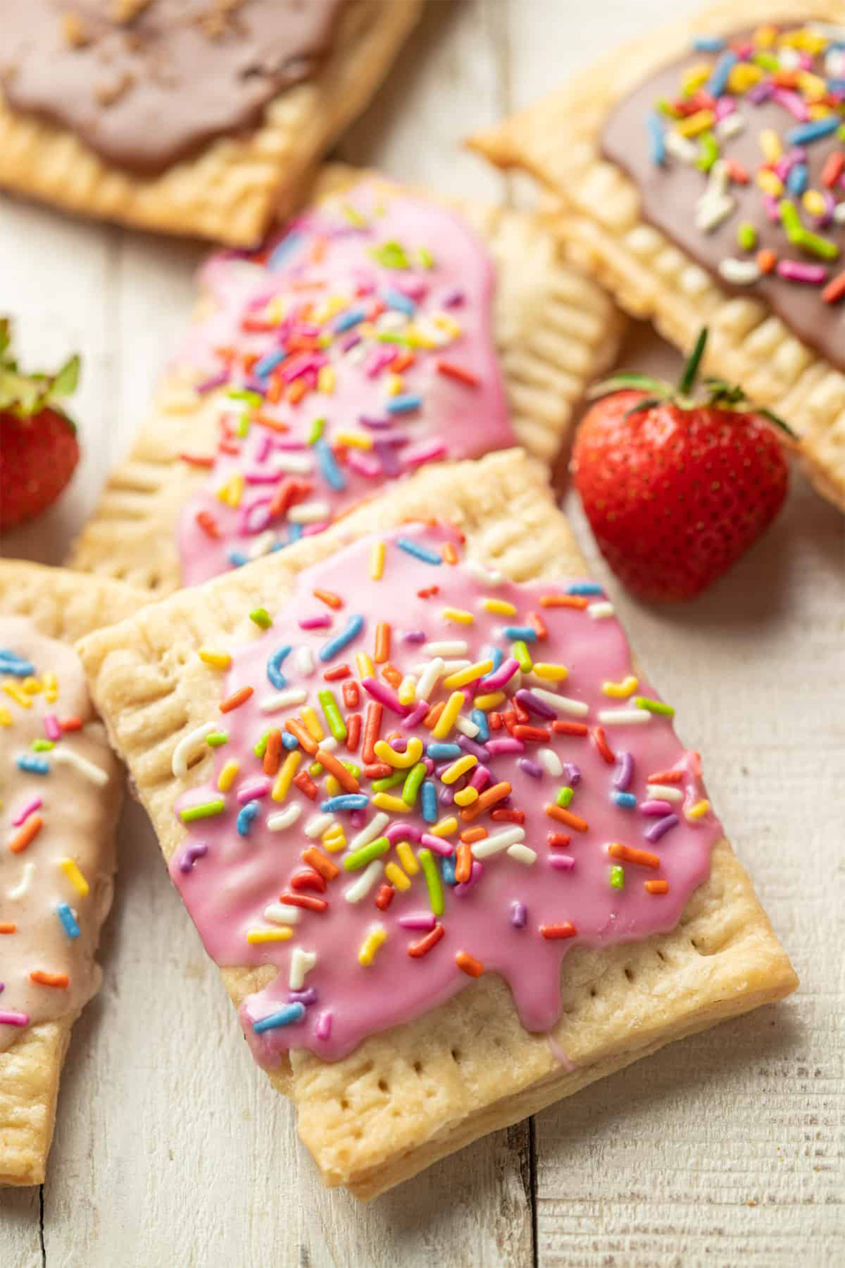 a batch of vegan poptarts topped with strawberry frosting and sprinkles