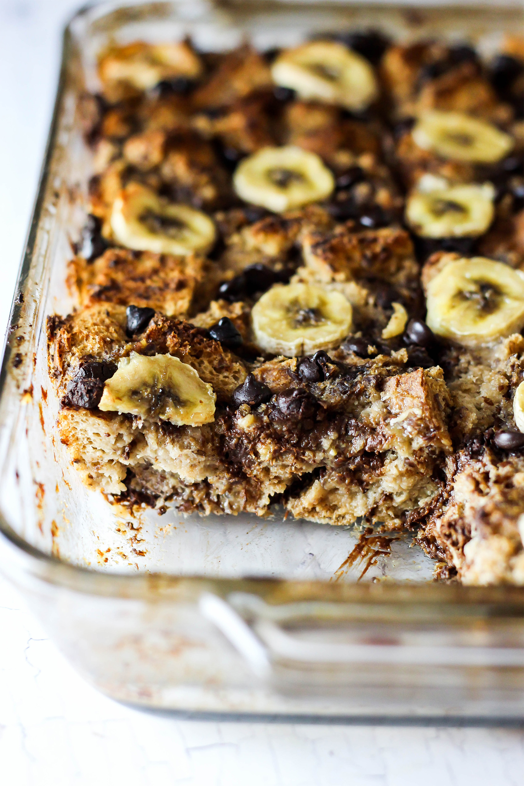 a casserole dish filled with chocolate banana baked oatmeal