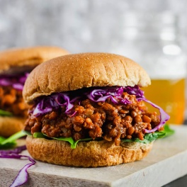 a lentil sloppy joe sandwich topped with purple cabbage