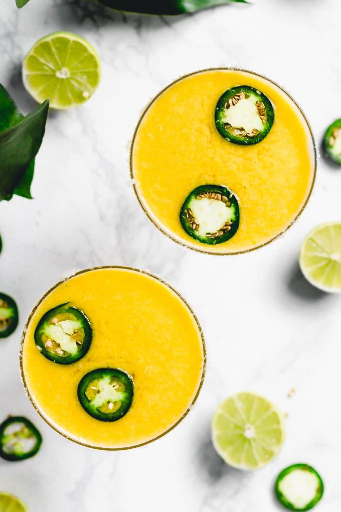 an overhead shot of two spicy margaritas