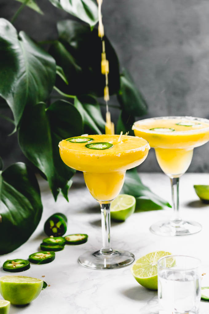 mango margarita being poured into a glass