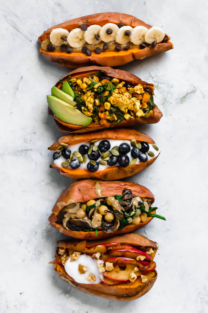 a lineup of baked sweet potatoes filled with vegan breakfast toppings such as yogurt and berries or tofu scramble