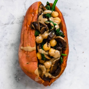 A sweet potato stuffed with sauteed spinach, mushrooms and chickpeas