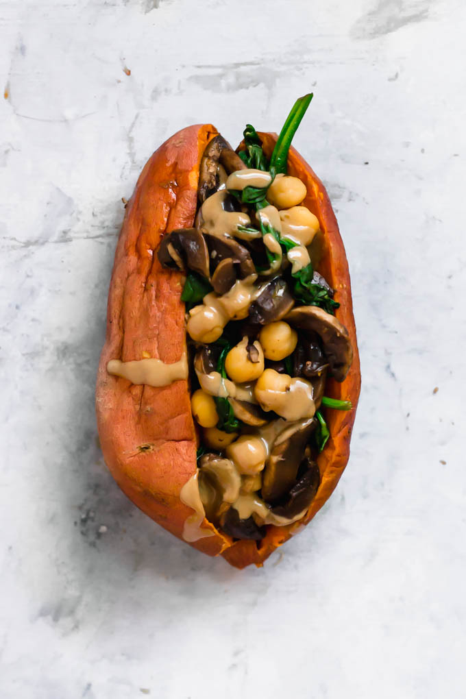 A sweet potato stuffed with sauteed spinach, mushrooms and chickpeas