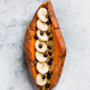 a sweet potato stuffed with sliced bananas, peanut butter and chocolate chips