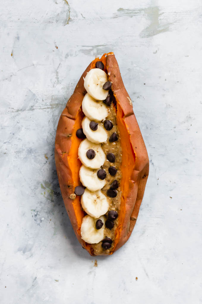a sweet potato stuffed with sliced bananas, peanut butter and chocolate chips