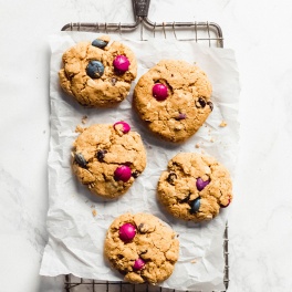 a cooling rack holding a batch of 5 monster cookies