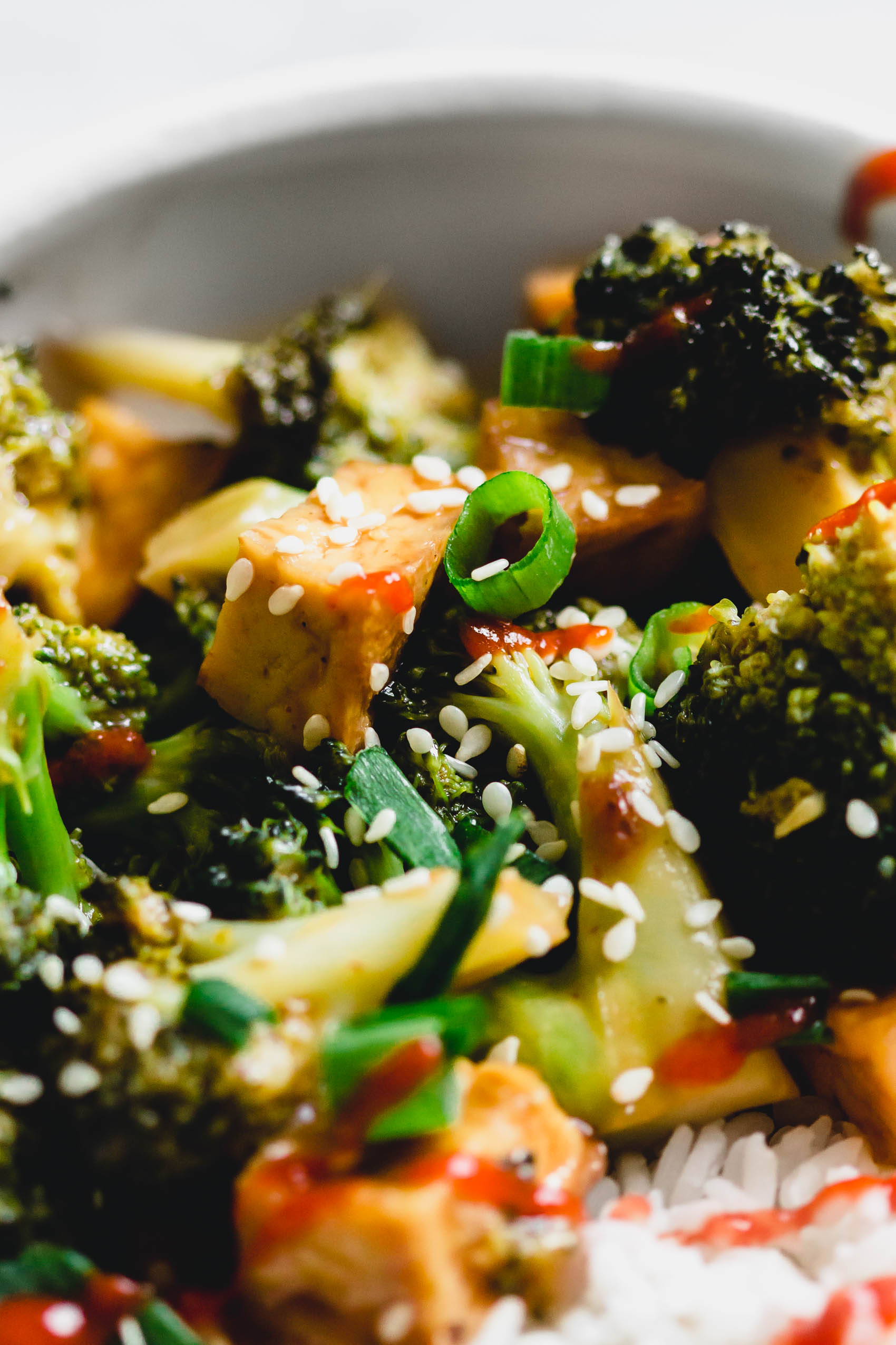 a close up of a dish of tofu and broccoli stir fry