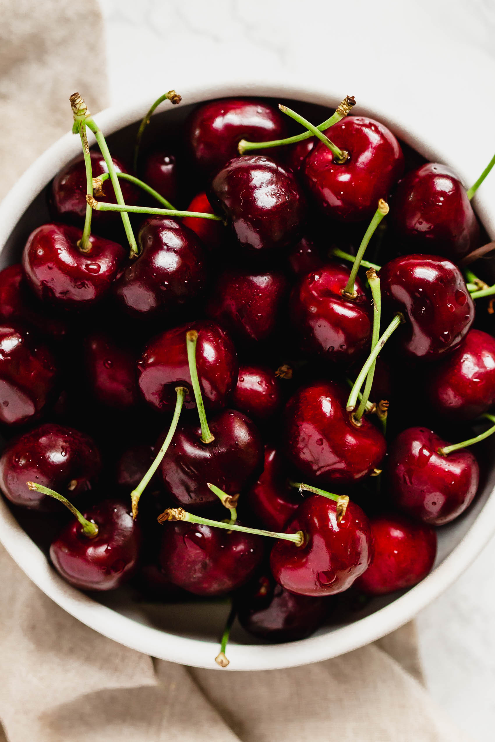 a bowl filled with sweet cherries