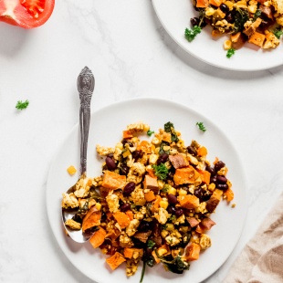 a plate of tofu scramble with sweet potato, black beans and tomatoes
