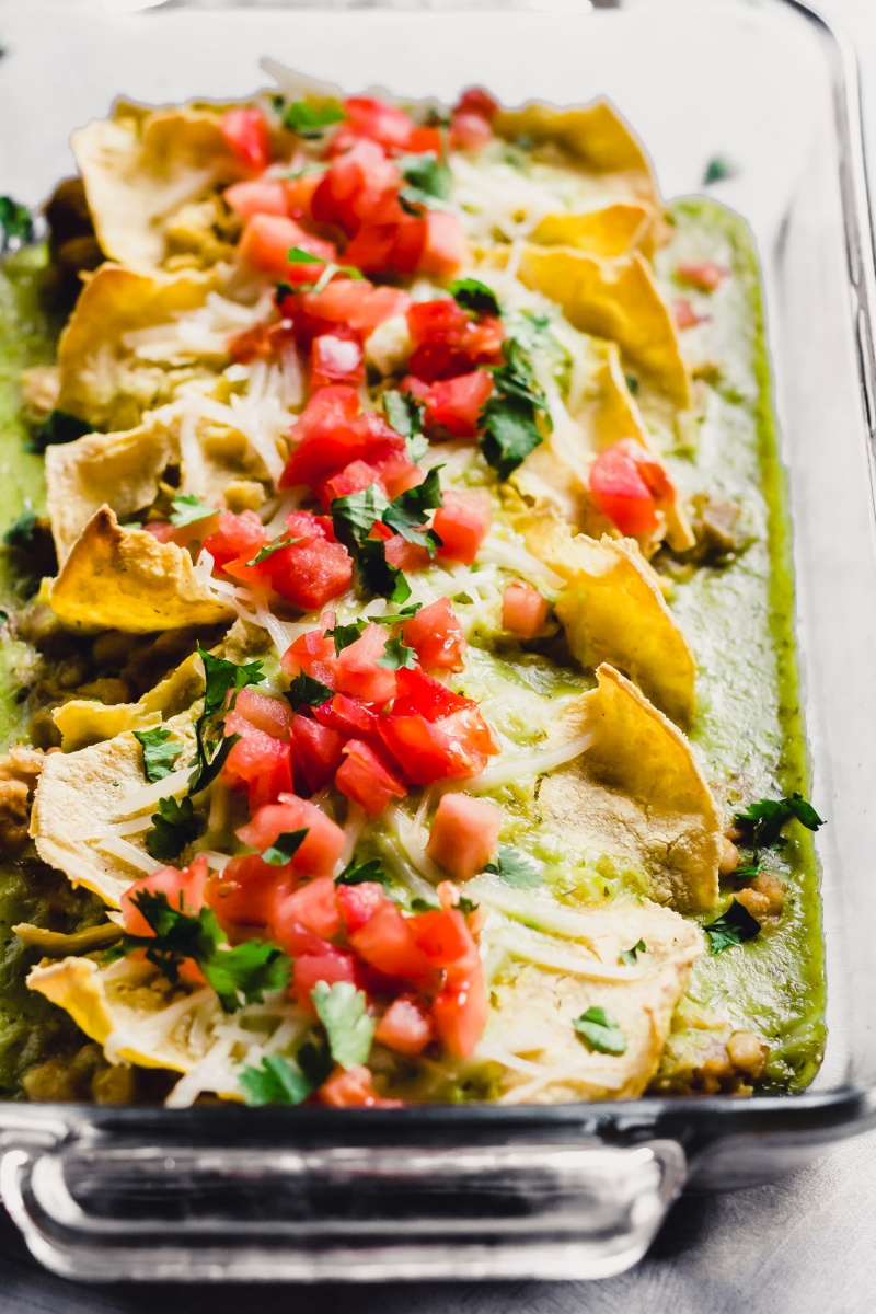 A pan of green vegan enchiladas