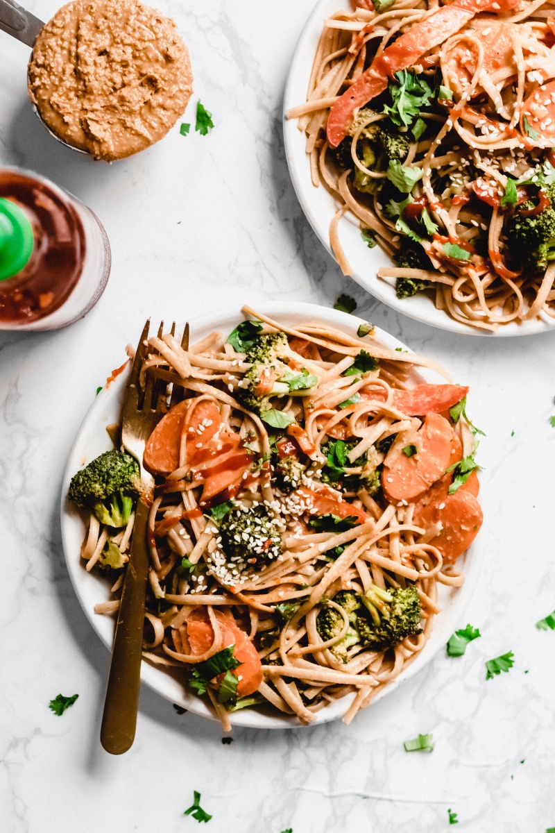 two plates with peanut butter noodles