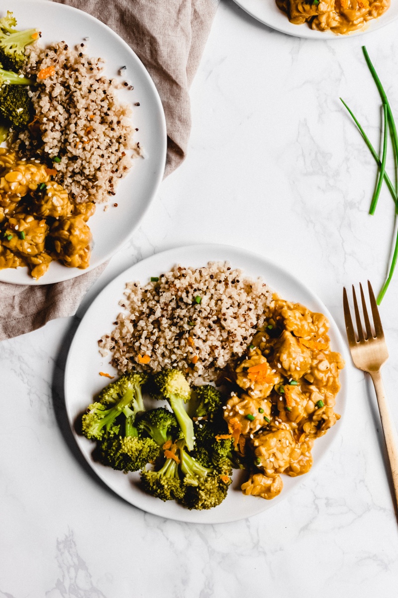 Vegan orange tempeh plated with quinoa and broccoli