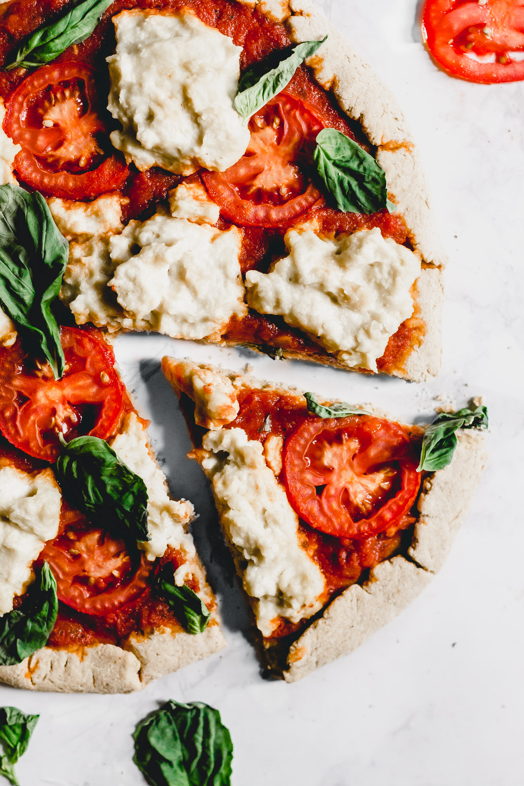 a slice of pizza sitting next to a whole pizza