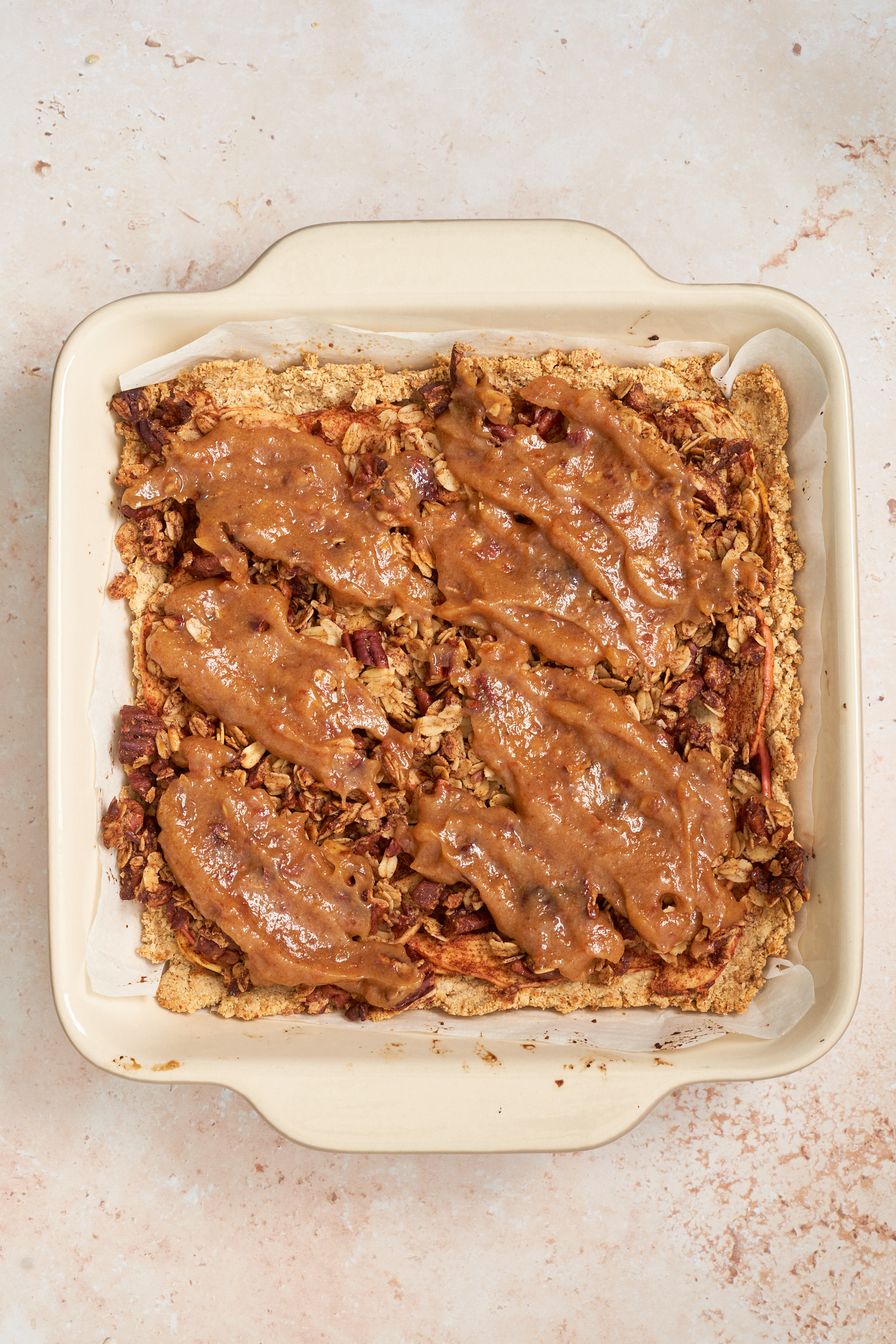 a dish of apple pie bars topped with salted caramel