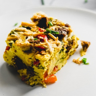 a slice of vegan breakfast casserole on a plate