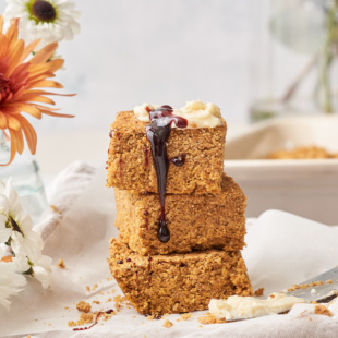 a stack of three pieces of cornbread being drizzled by molasses