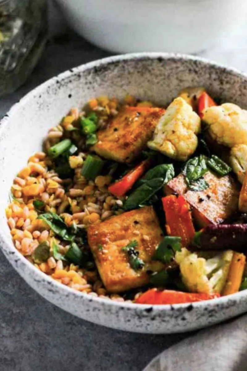 pottery bowl with rice and glazed tofu with vegetables