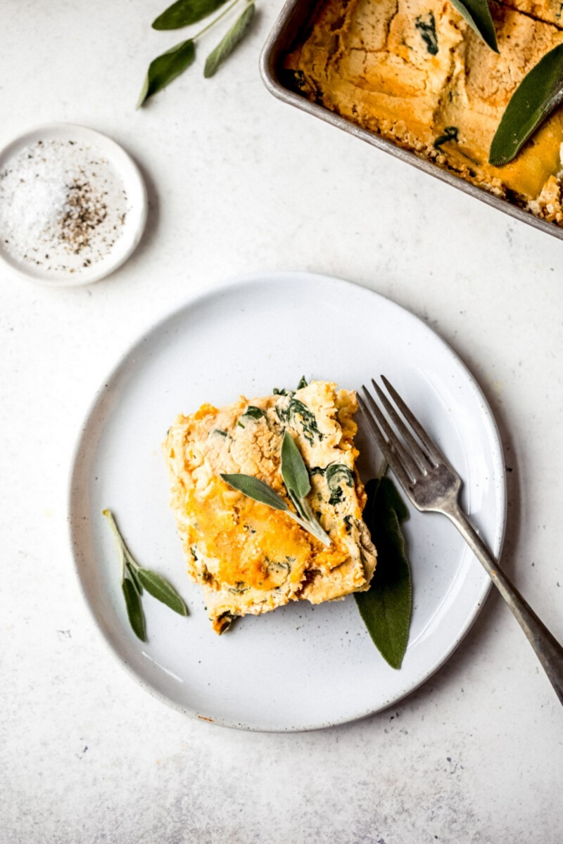 slice of butternut squash lasagna on a plate with a fork