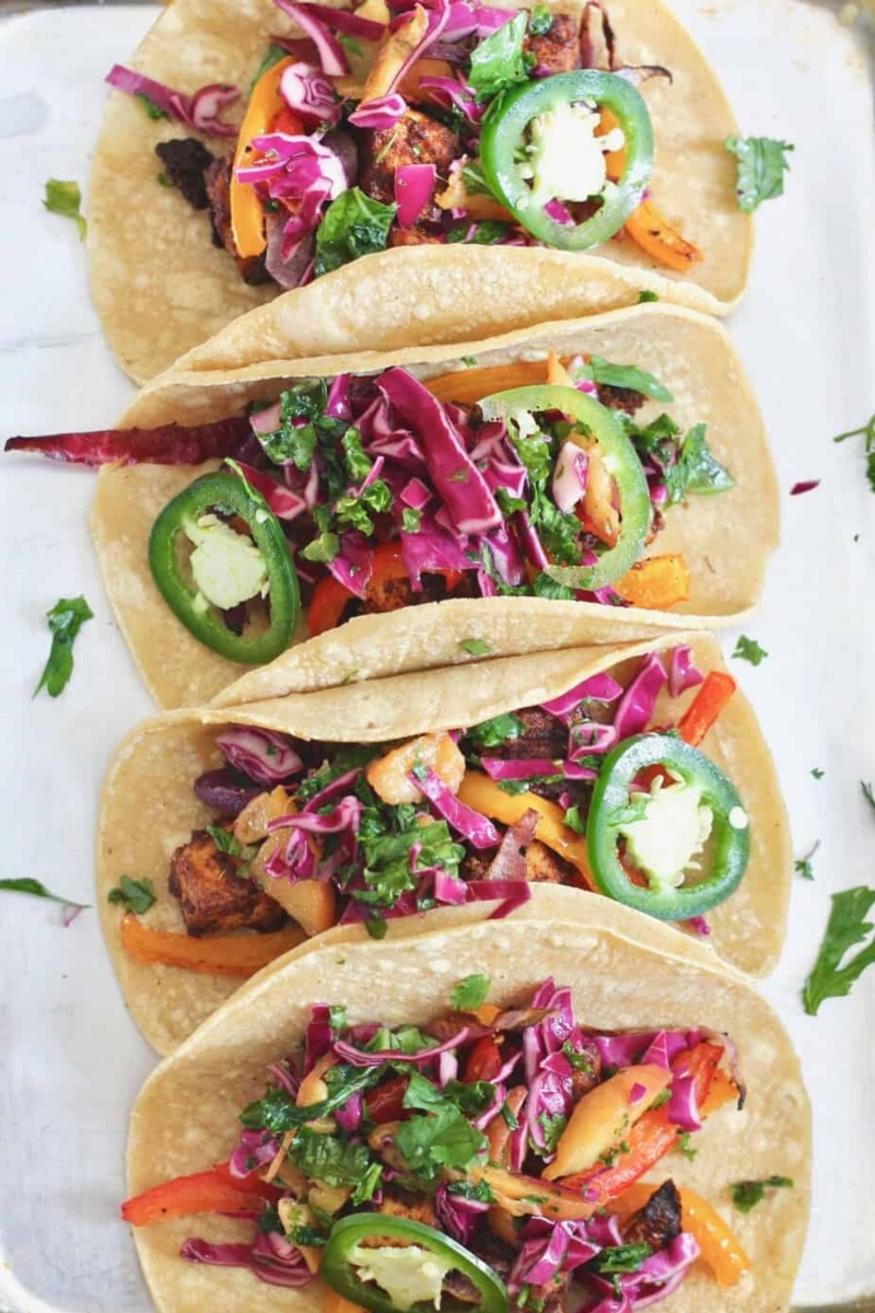 four tacos on a white board 