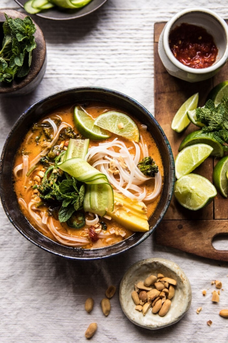 black bowl with noodle soup and lime slices