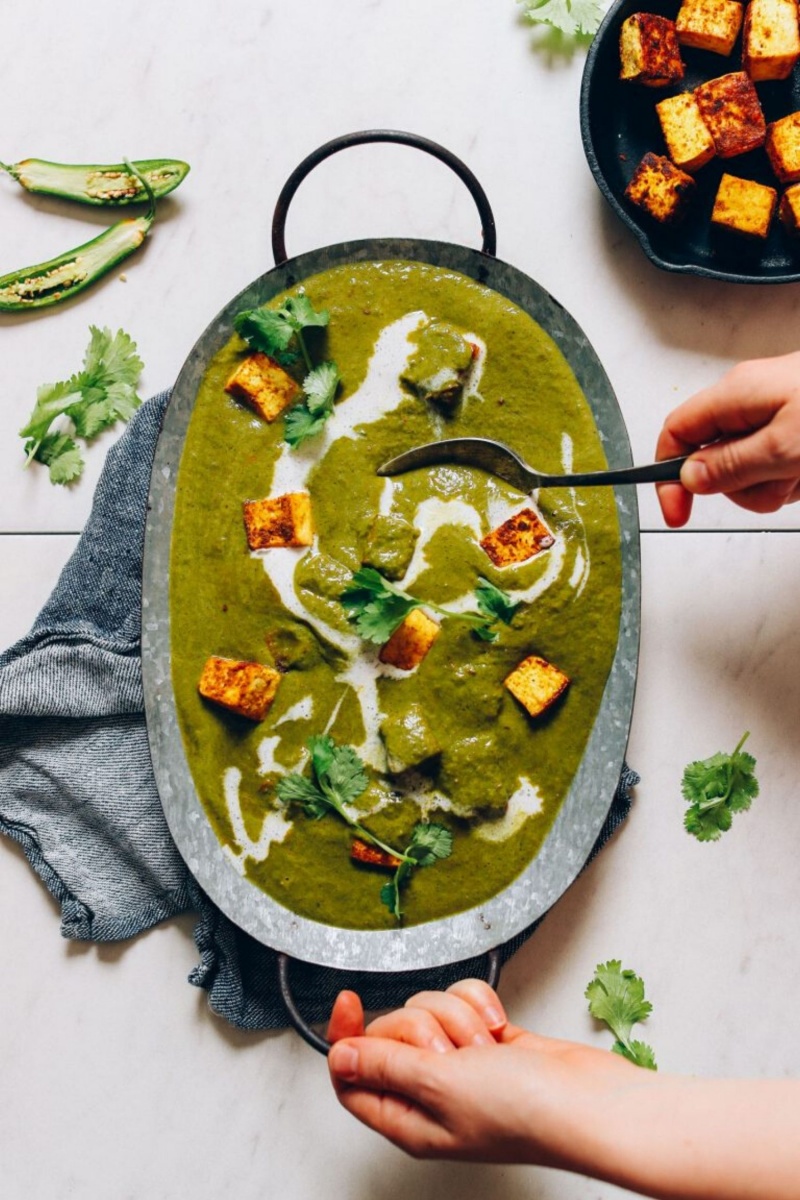 grey dish with green palak paneer and coconut milk swirls 