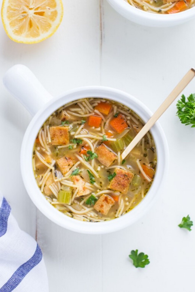 noodle soup with vegetables in a white bowl 