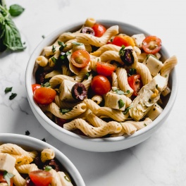 bowl of pasta with tomatoes and cheese