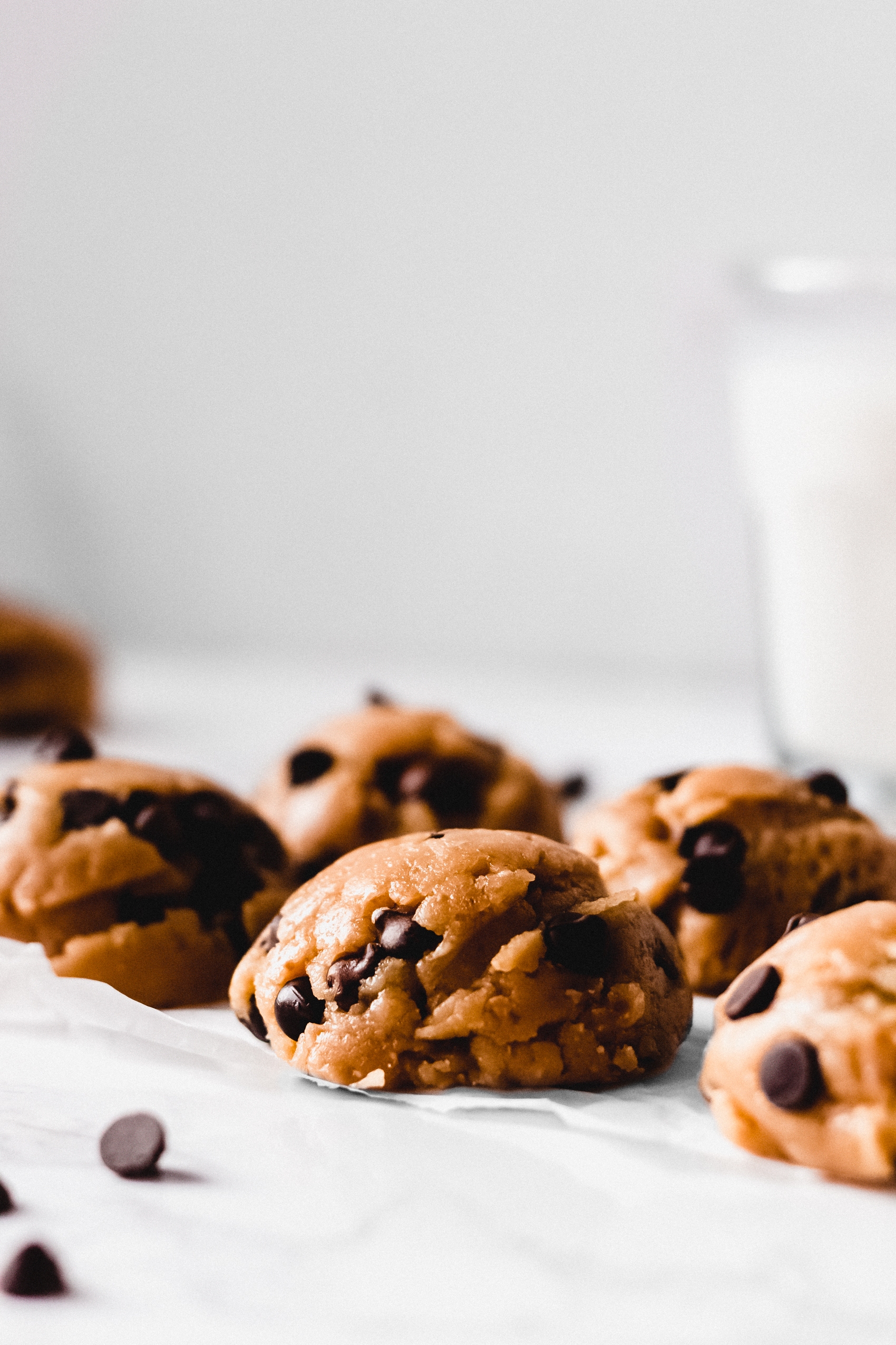 a closeup of a batch of six chocolate chip cookie dough balls