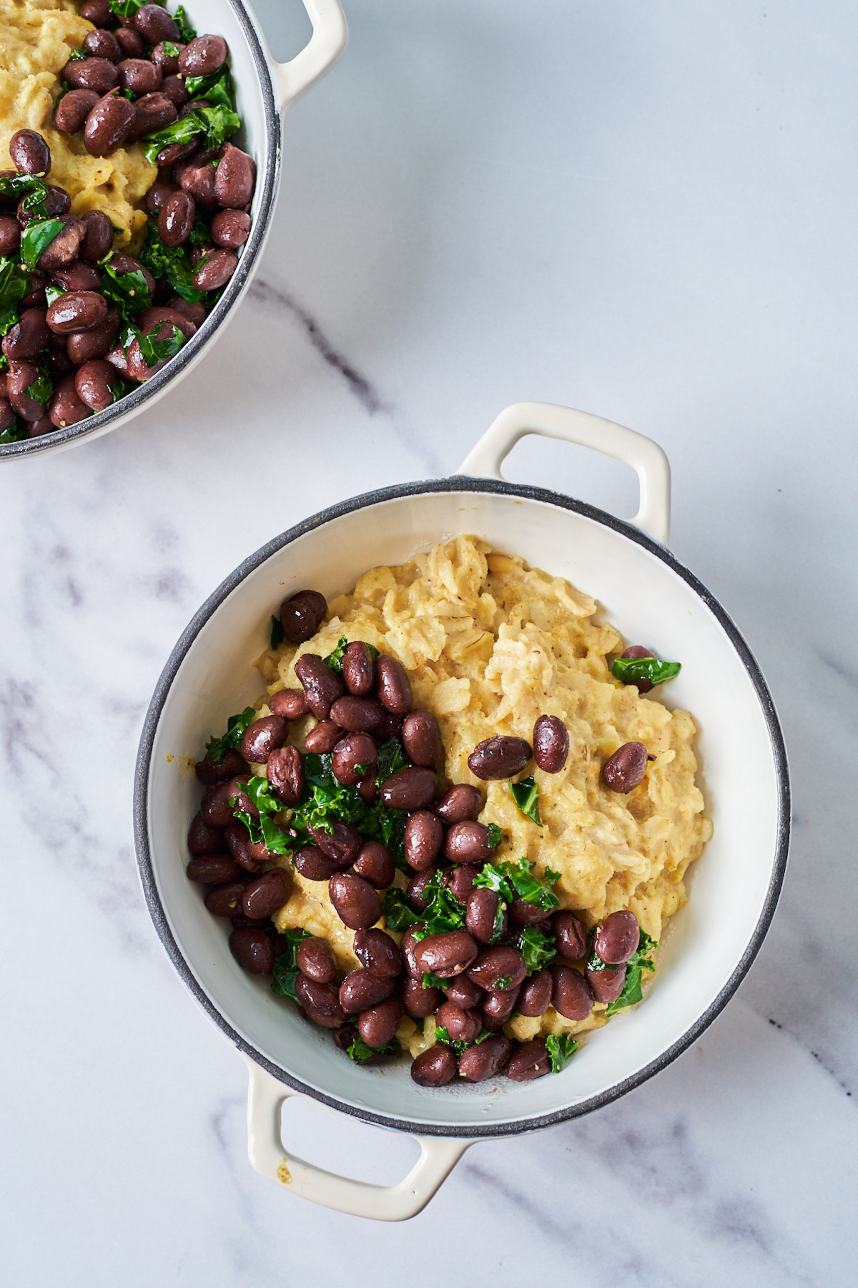 a pot of cooked oats topped with black beans