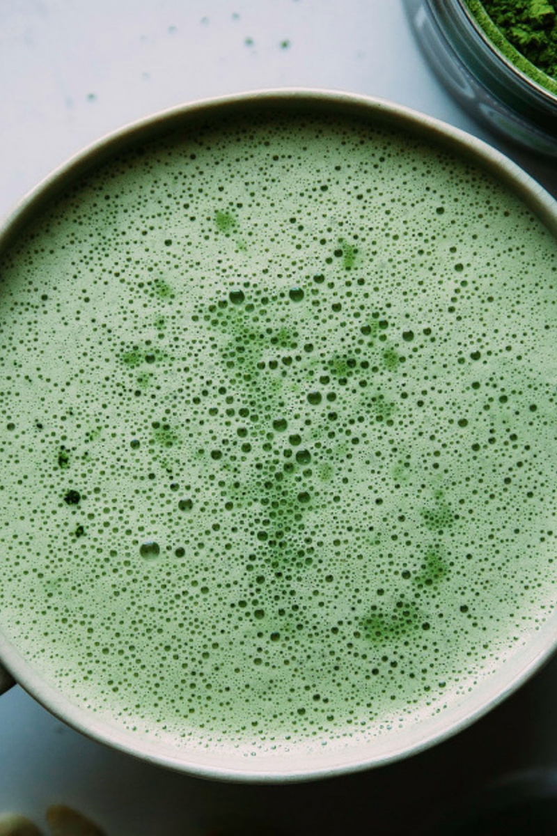 close up birds eye image of bubbly green matcha latte