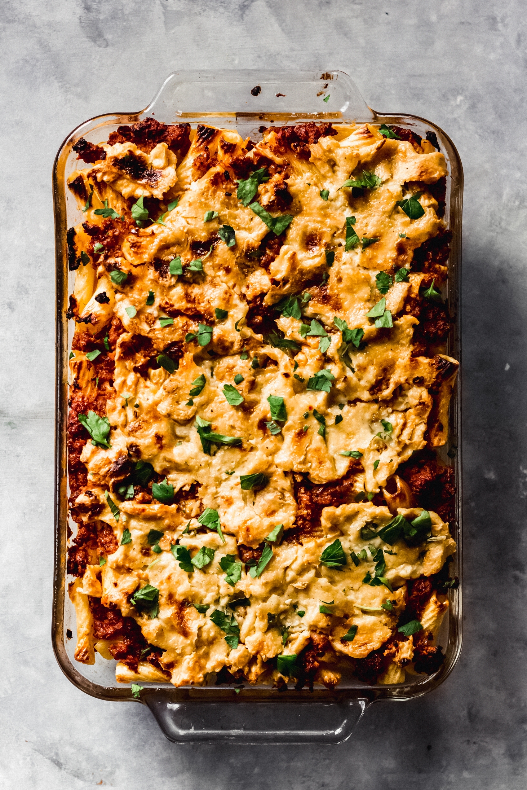 a dish of vegan baked ziti topped with fresh parsley