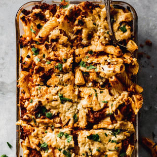 a casserole dish filled with baked ziti sliced into 8 pieces