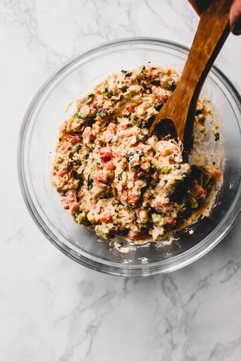 glass bowl with vegan tuna salad and a wooden spoon