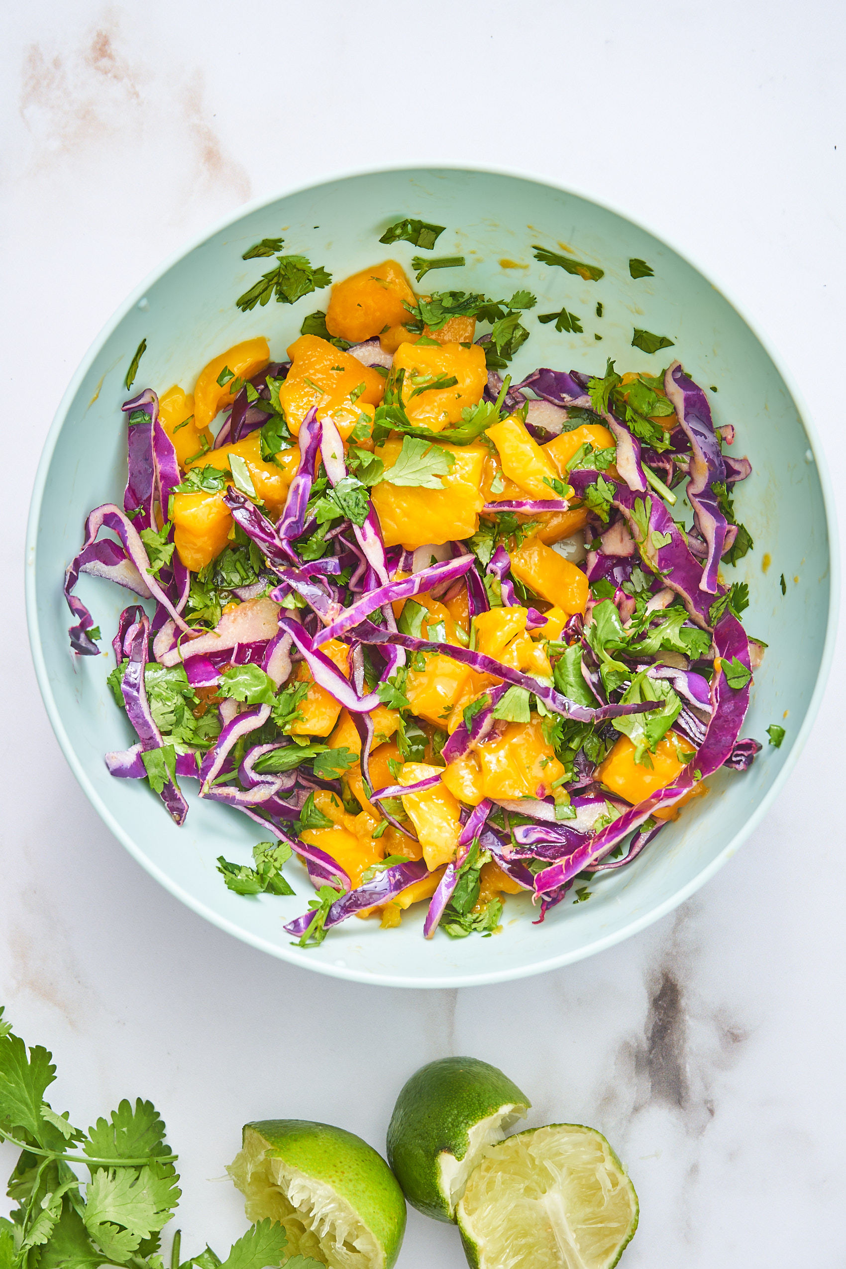 a bowl of cabbage and mango slaw