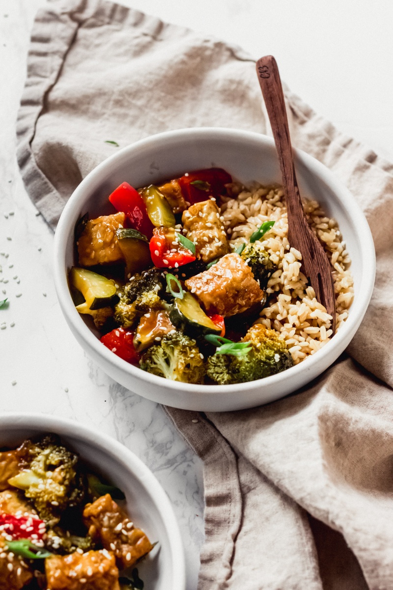 a bowl of brown rice and teriyaki tempeh stir fry